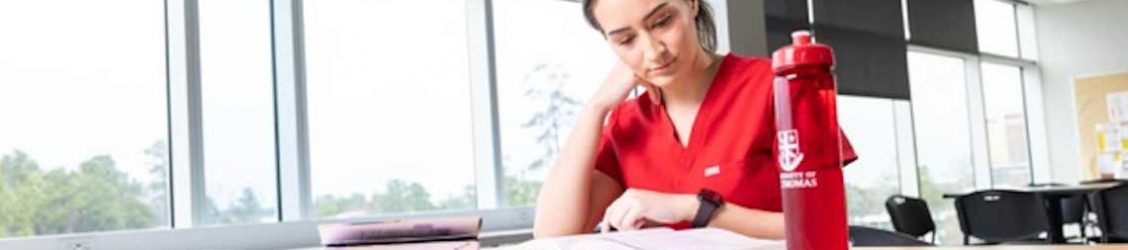 nursing student studying at a table