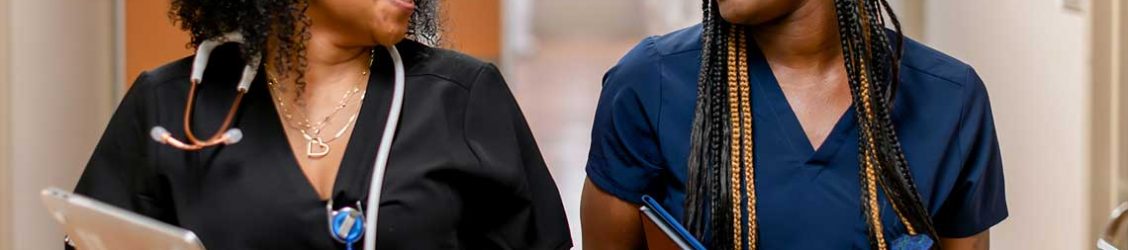 two nursing students talking in hallway
