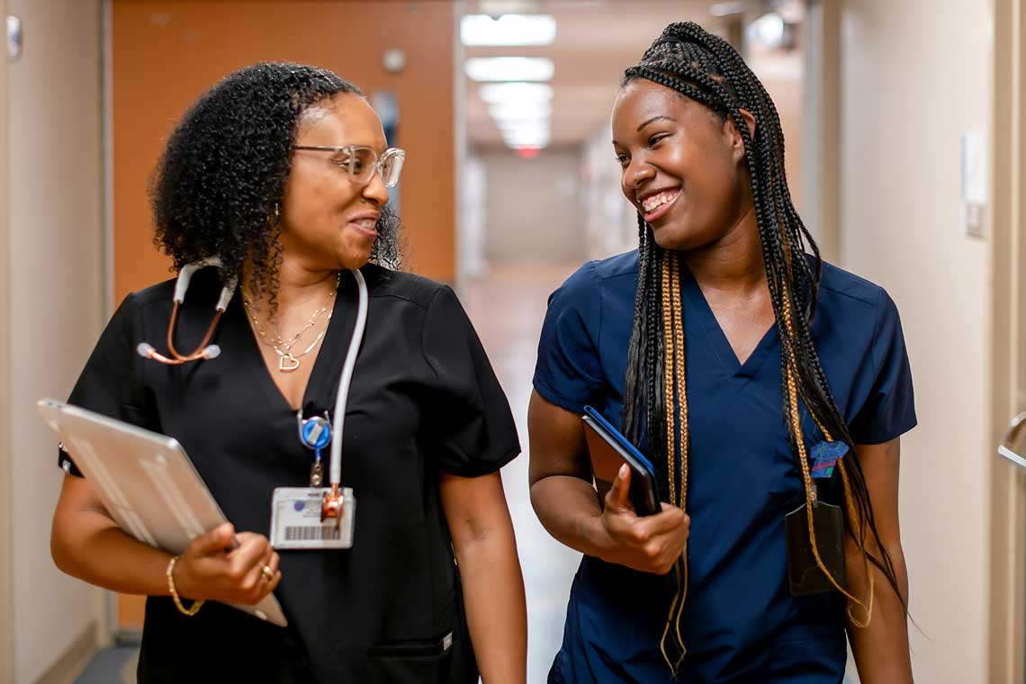 two nursing students talking in hallway