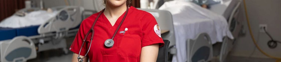 Nursing student sitting down and posing
