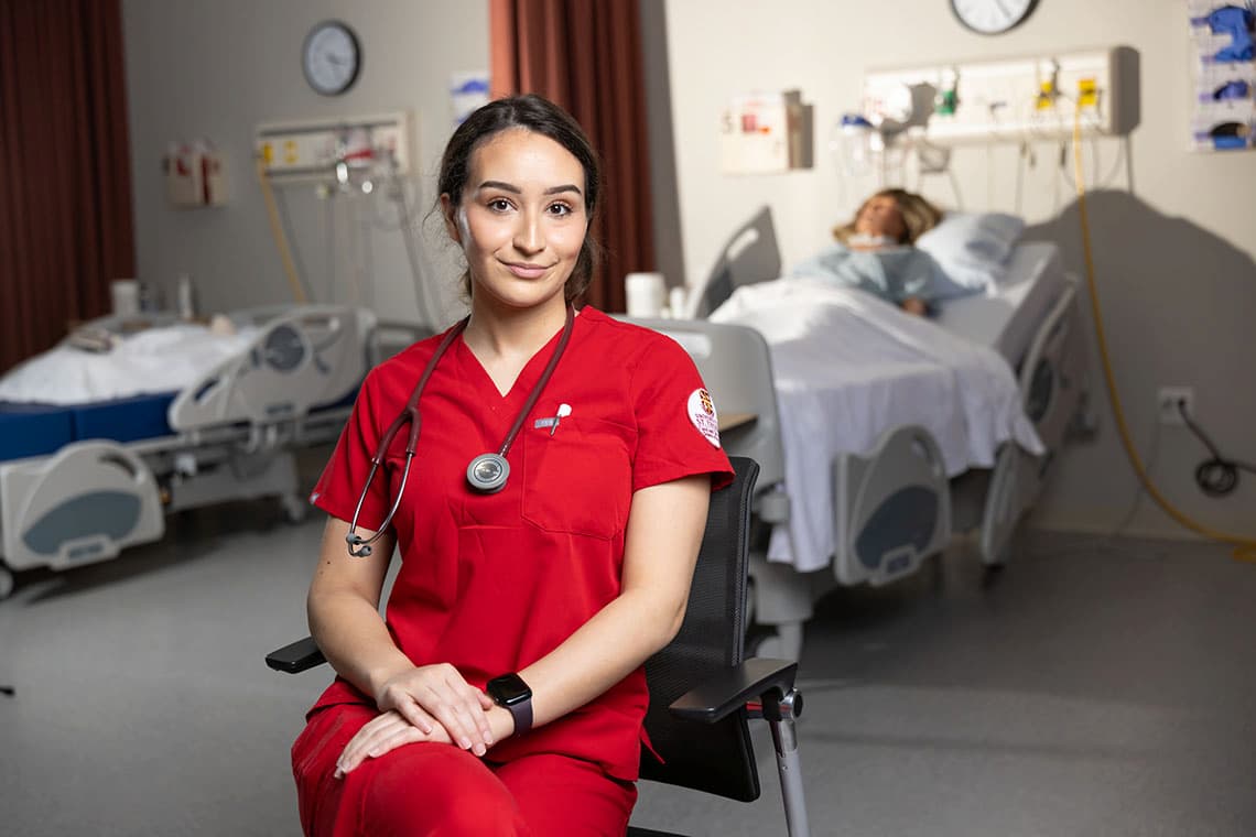 Nursing student sitting down and posing